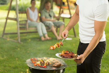 Host serving delicious grilled meal