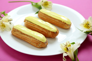 Eclairs with glaze on a paper background