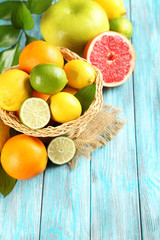 Naklejka na ściany i meble Citrus fruits on a blue wooden table