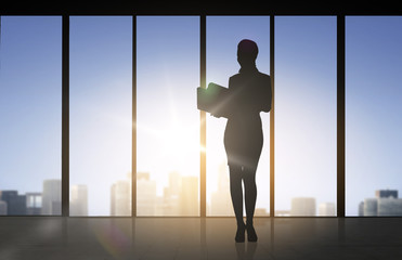 silhouette of business woman with folders
