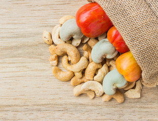 raw cashew nuts Fresh Cashew Nut pour from sack on wood