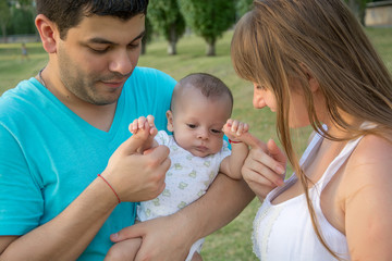 parents with baby in park