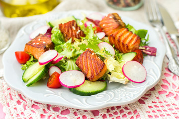 Salad with grilled salmon, radish and cucumber