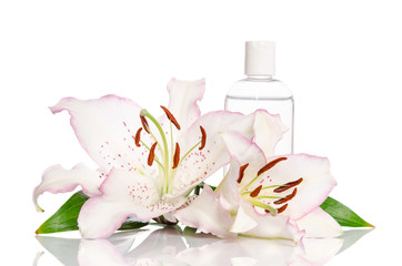 Obraz na płótnie Canvas tonic for skin care with lily flower on a white background