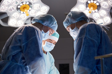 group of surgeons in operating room at hospital