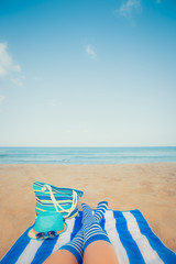 Slim woman legs on a beach