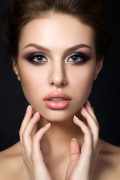 Portrait of young beautiful woman with evening make up