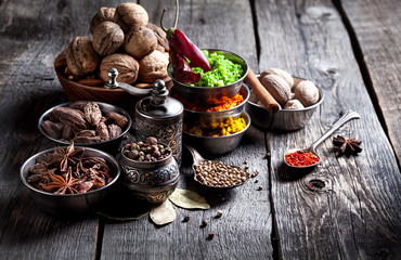 Spices and nuts at wooden table