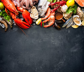 Shellfish plate of crustacean seafood with fresh lobster, mussels, oysters as an ocean gourmet dinner background - obrazy, fototapety, plakaty
