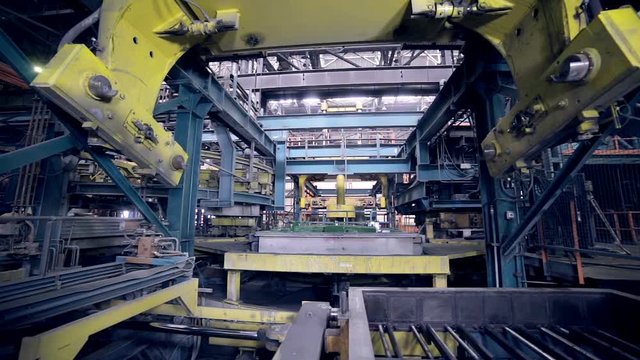 Robot making car parts at factory. Automative metal casting. HD.