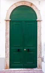 Green door. entrance door in front of residential house.