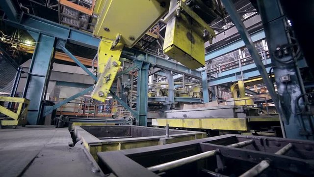 Robot making car parts at factory. Automative metal casting. HD.