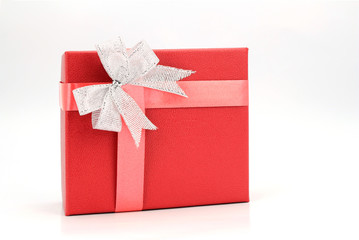 red gift box with silver ribbon on white background.