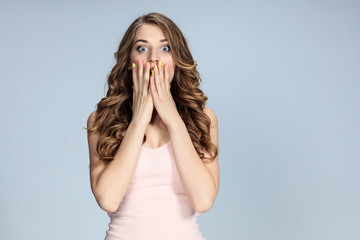 Portrait of young woman with shocked facial expression