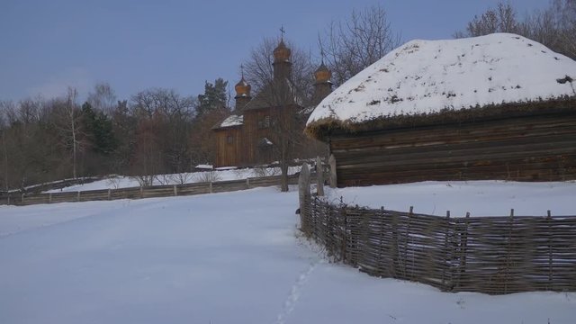 Wooden Church Behind a Rustic Huts Winter Snow Wattle Fence Church of the Holy Michael the Archangel Towers Cupolas Pirogovo Forest is Around a Village