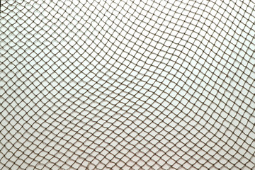 Close up of fish net against white background - obrazy, fototapety, plakaty