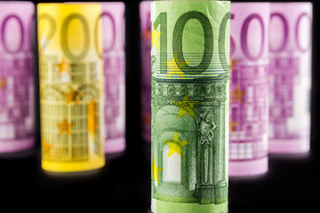 closeup view of 100 euro rolled banknote
