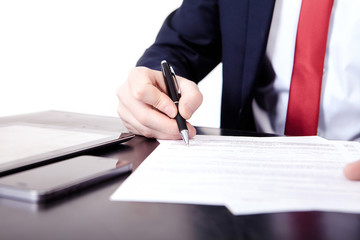 Low angle view of the fingers of a man writing on a document with a fountain pen conceptual of communication, correspondence, business agreement, legal contract or creativity