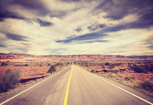Vintage stylized picture of a scenic desert road.