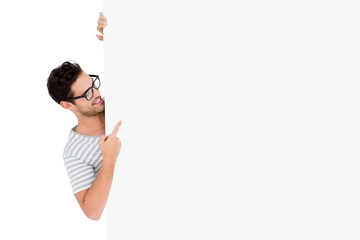 Man in spectacles hiding behind the white board
