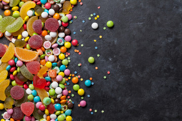 Colorful candies, jelly and marmalade over stone