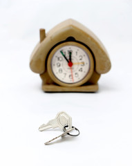 keys in front of vintage house shape alarm clock