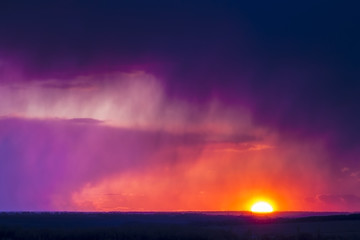 Sunset or sunrise sun and clouds, red. Bright contrast picture of nature.