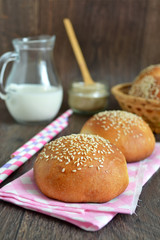 homemade buns with sesame seeds and milk for breakfast