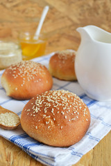 homemade buns with sesame seeds and milk for breakfast