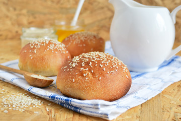 homemade buns with sesame seeds and milk for breakfast