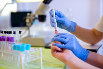 Measure child glucose level blood test diabetes little girl usin