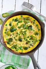 Frittata with cheese, green peas and Brussels sprouts