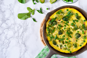 Frittata with cheese, green peas and Brussels sprouts