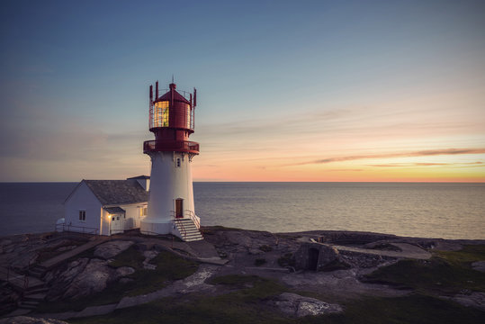 Lighthouse Lindesnes Fyr at sunset on most southern point of Norway, Europe, Vintage filtered style
