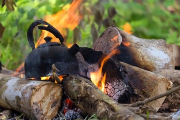 Burnt kettle on campfire