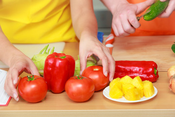 Couple preparing fresh vegetables food salad