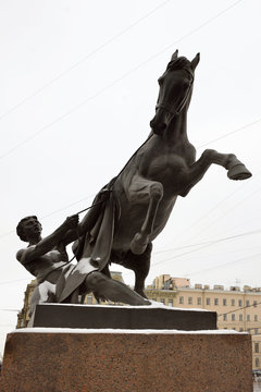 Sculpture tamer of horses, designed by the Russian sculptor Baron Peter Klodt. Anichkov bridge, St. Petersburg, Russia, 1841