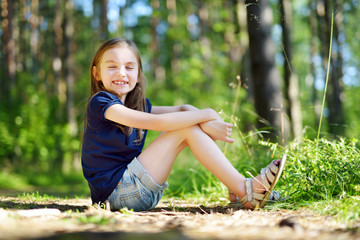 Adorable little girl hiking in the forest on summer day © MNStudio