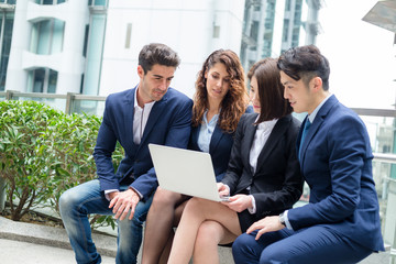 Group of business people working on laptop computer