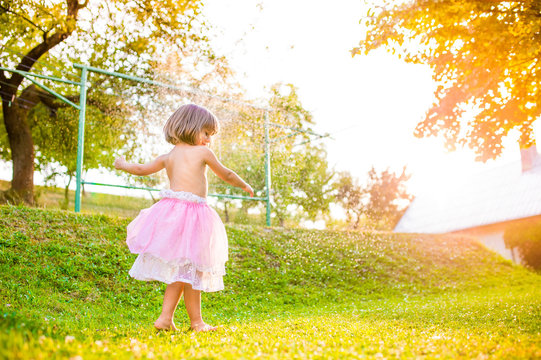 Girl In Princess Skirt Running In Sunny Summer Garden