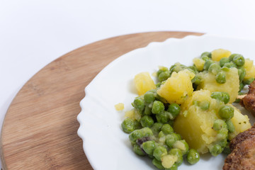 Potato and green peas salad on the plate
