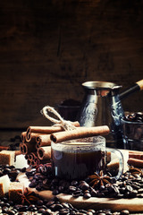 Fototapeta na wymiar Espresso, coffee maker, spilled coffee beans, spices, sugar, vin