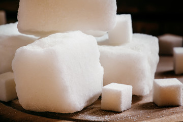 Large pieces of white refined sugar, vintage wooden background,