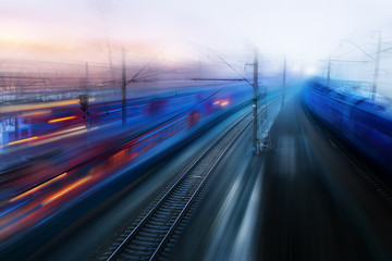 Fototapeta na wymiar movement of trains in the ways of evening twilight fog Spring