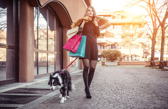 Fashionable Woman And Her Border Collie Dog Making Shopping In T