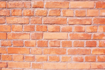 Background of peach fuzz colored brick wall