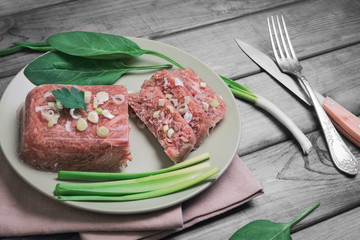 Jellied meat jelly on a green plate