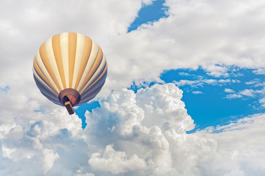 hot air balloon with blue cloudy sky background