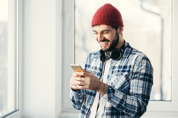 Smiling handsome young man texting
