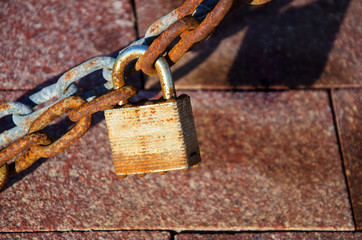 Old lock with chain at sunset